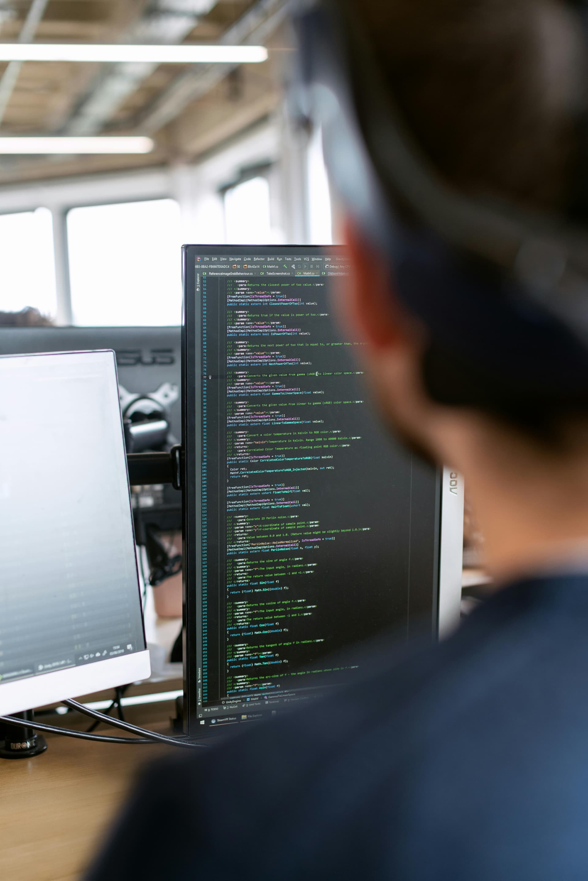 AI engineering copilot accelerating software development - developer with headphones focused on AI-assisted coding for business productivity